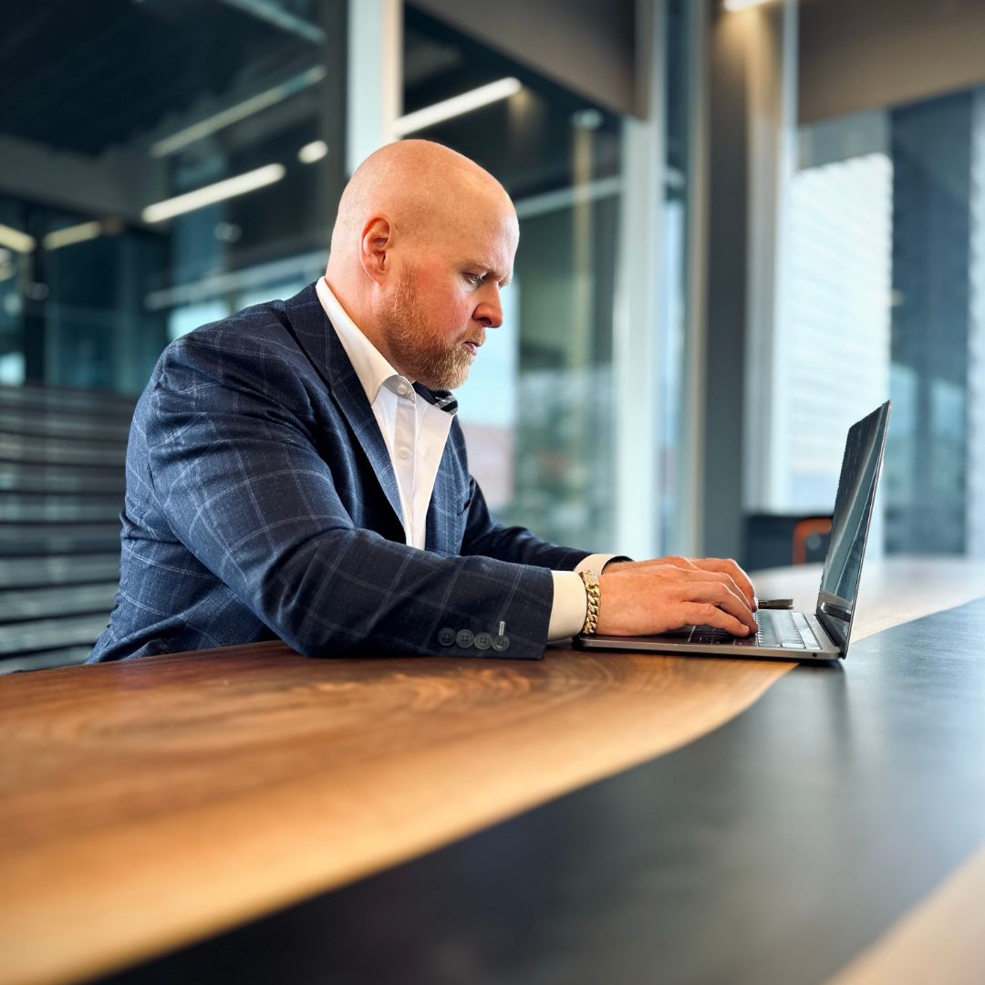 Top Mortgage Broker in Canada, Dave Butler, typing mortgage information on a laptop computer.